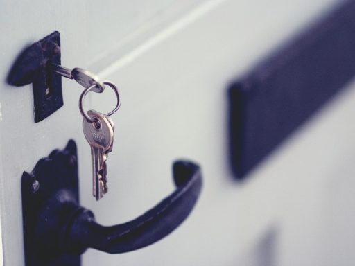 black and silver padlock on white door