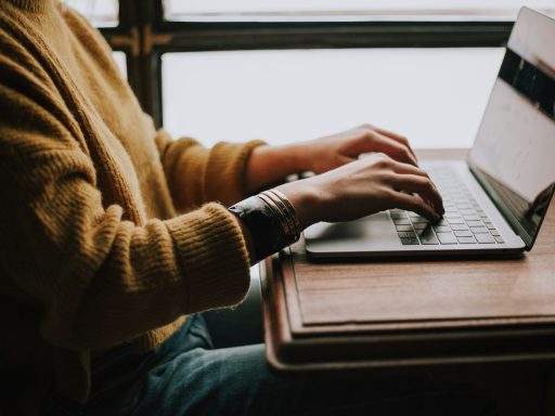 person sitting front of laptop