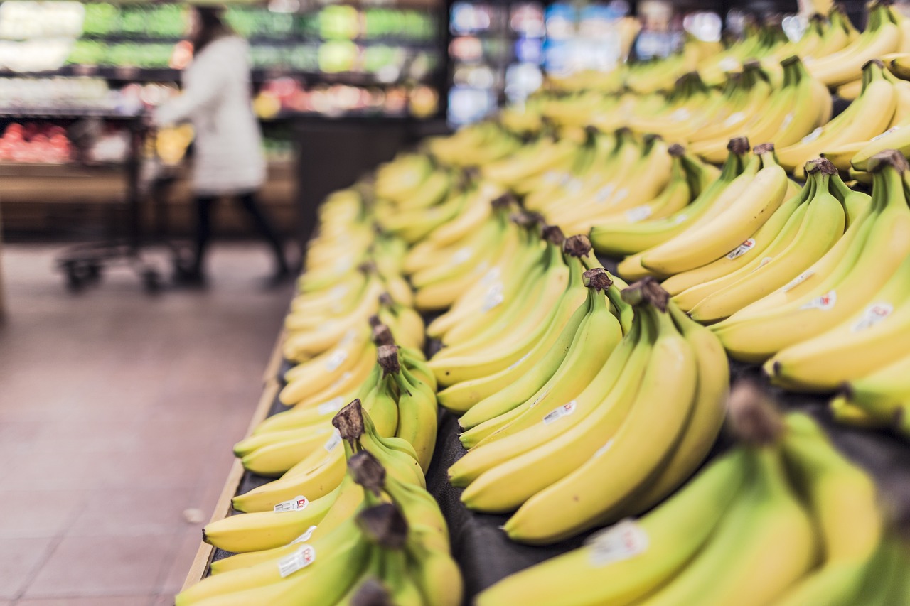 Spaarmuntjes van een supermarkt spaarprogramma naast een spaarbankje op een keukentafel