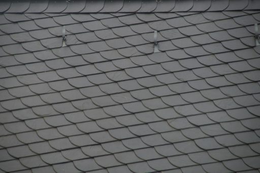 Renovatiewerker die dakisolatie aanbrengt op een woning